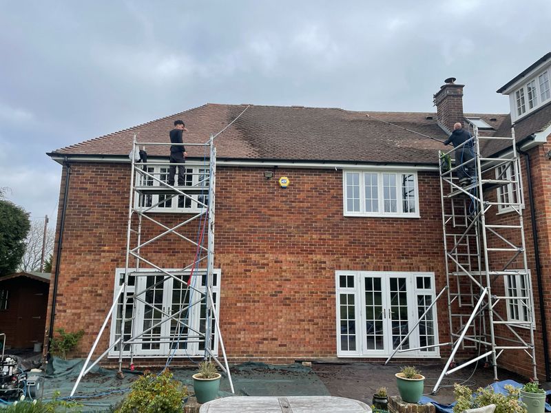Roof cleaning carried out safely from scaffold towers by The Roof Moss Cleaners in Earls Barton